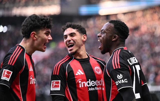 Frankfurt's French forward #25 Arnaud Kalimuendo (R) celebrates his 1-0 with Frankfurt's Turkish forward #42 Can Uzun (L) and Frankfurt's Algerian midfielder #08 Fares Chaibi (C) during the German first division Bundesliga football match between Eintracht Frankfurt and TSG 1899 Hoffenheim in Frankfurt am Main, western Germany, on January 24, 2026. (Photo by Kirill KUDRYAVTSEV / AFP) / DFL REGULATIONS PROHIBIT ANY USE OF PHOTOGRAPHS AS IMAGE SEQUENCES AND/OR QUASI-VIDEO