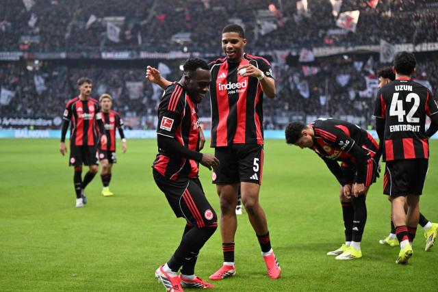 Frankfurt's French forward #25 Arnaud Kalimuendo (C L) celebrates his 1-0 with team mates during the German first division Bundesliga football match between Eintracht Frankfurt and TSG 1899 Hoffenheim in Frankfurt am Main, western Germany, on January 24, 2026. (Photo by Kirill KUDRYAVTSEV / AFP) / DFL REGULATIONS PROHIBIT ANY USE OF PHOTOGRAPHS AS IMAGE SEQUENCES AND/OR QUASI-VIDEO
