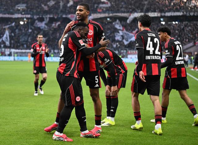 Frankfurt's French forward #25 Arnaud Kalimuendo (L) celebrates his 1-0 with team mates during the German first division Bundesliga football match between Eintracht Frankfurt and TSG 1899 Hoffenheim in Frankfurt am Main, western Germany, on January 24, 2026. (Photo by Kirill KUDRYAVTSEV / AFP) / DFL REGULATIONS PROHIBIT ANY USE OF PHOTOGRAPHS AS IMAGE SEQUENCES AND/OR QUASI-VIDEO
