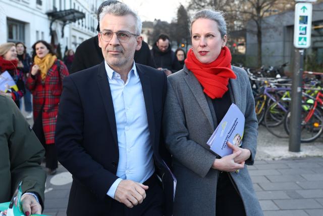 Mayor of Tours and candidate for his reelection Emmanuel Denis (L) and French civil servant and economist Lucie Castets walk outside as they campaign for the upcoming municipal elections in Tours, western France on January 24, 2026. (Photo by ROMAIN PERROCHEAU / AFP)