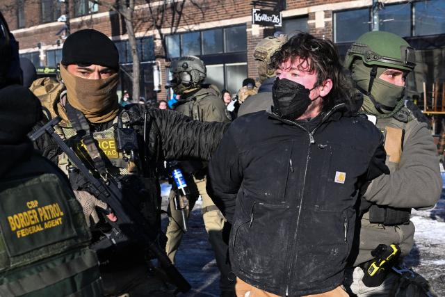 A man is detained by federal law enforcement, near the site of where state and local authorities say a man was shot by federal agents earlier in the morning in Minneapolis, Minnesota, on January 24, 2026. Minnesota Governor Tim Walz said Saturday that federal agents deployed in Minneapolis as part of a sweeping immigration crackdown had carried out "another horrific shooting," less than three weeks after the fatal shooting of Renee Good. (Photo by ROBERTO SCHMIDT / AFP)