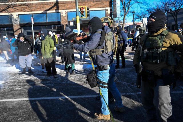 Fedearl agents respond as demonstators gather near the site of where state and local authorities say a man was shot by federal agents earlier in the morning in Minneapolis, Minnesota, on January 24, 2026. Minnesota Governor Tim Walz said Saturday that federal agents deployed in Minneapolis as part of a sweeping immigration crackdown had carried out "another horrific shooting," less than three weeks after the fatal shooting of Renee Good. (Photo by ROBERTO SCHMIDT / AFP)