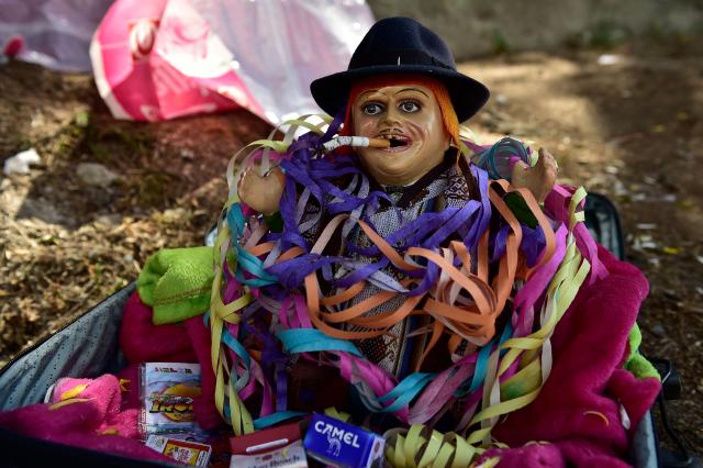 A toy representing Aymara god 'Ekeko' is displayed during the Alasitas indigenous festivity fair in La Paz on January 24, 2026. The festivity pays homage to the 'Ekeko' that according to the Andean tradition, provides earthly wealth and pleases the requests of its worshipers, who buy miniature goods representing their hopes for the coming year. (Photo by Jorge BERNAL / AFP)