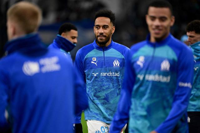 Marseille's Gabonese forward #97 Pierre-Emerick Aubameyang (C) and team mates warm up ahead of the French L1 football match between Olympique de Marseille (OM) and RC Lens at the Stade Velodrome in Marseille, southern France, on January 24, 2026. (Photo by Miguel MEDINA / AFP)