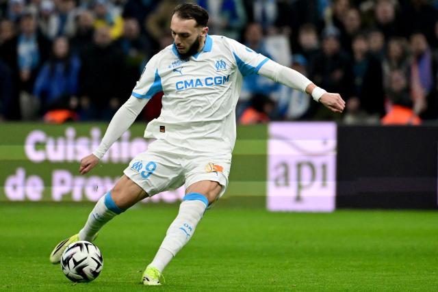 Marseille's Algerian forward #09 Amine Gouiri takes a shot during the French L1 football match between Olympique de Marseille (OM) and RC Lens at the Stade Velodrome in Marseille, southern France, on January 24, 2026. (Photo by Miguel MEDINA / AFP)