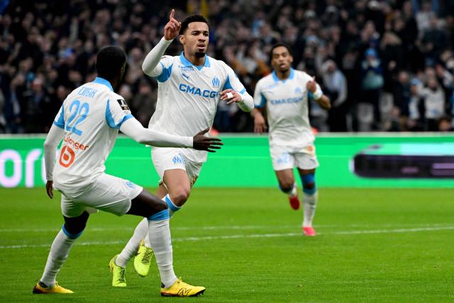 Marseille's English midfielder #11 Ethan Nwaneri (C) celebrates after scoring a goal during the French L1 football match between Olympique de Marseille (OM) and RC Lens at the Stade Velodrome in Marseille, southern France, on January 24, 2026. (Photo by Miguel MEDINA / AFP)