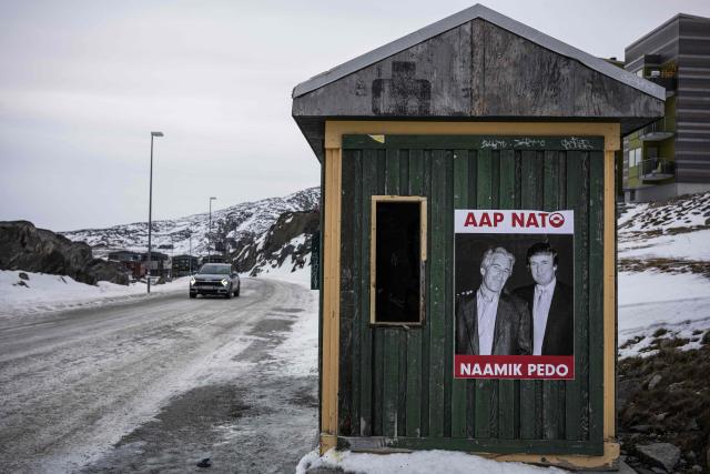 A poster showing Jeffrey Epstein and US President Donald Trump with the text in Greenlandic “YES NATO NO PEDO” is displayed on a bus stop shelter in Nuuk, Greenland, on January 24, 2026. (Photo by Jonathan NACKSTRAND / AFP)
