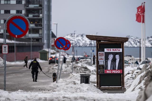 A poster showing Jeffrey Epstein and US President Donald Trump with the text in Greenlandic and English “YES NATO NO PEDO” is displayed on a bus stop shelter in Nuuk, Greenland, on January 24, 2026. (Photo by Jonathan NACKSTRAND / AFP)