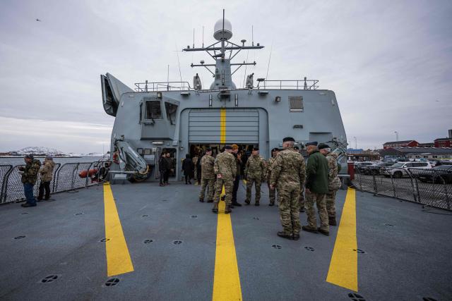 Members of the public and uniformed personnel stand on the deck of the Royal Danish Navy patrol vessel HDMS Vædderen (F359) as the ship opens to visitors during a public open day in Nuuk, Greenland, on January 24, 2026. HDMS (His Danish Majesty's Ship) Vaedderen (F359) is a Thetis-class ocean patrol vessel of the Royal Danish Navy. The vessel is employed to exercise Danish sovereignty in waters around the Faroe Islands and Greenland. (Photo by Jonathan NACKSTRAND / AFP)