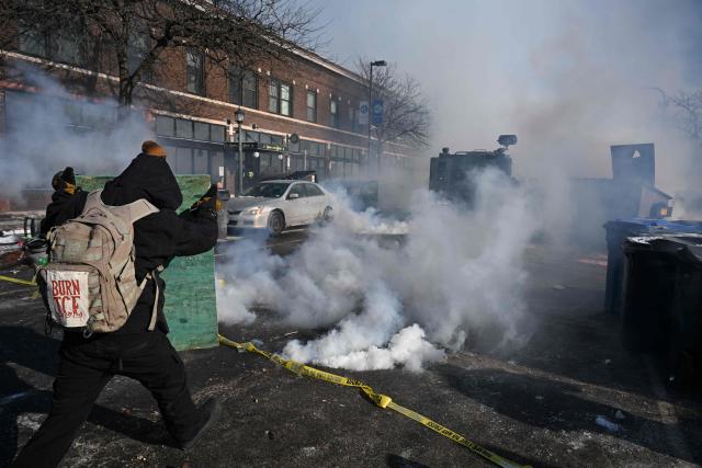 Protesters kick gas canisters thrown to them by Minneapolis police officers near where a man was shot and killed by federal immigration agents in Minneapolis, Minnesota, on January 24, 2026. Federal immigration agents shot dead a man in Minneapolis on Saturday, officials said -- the second fatal shooting of a civilian in the city, sparking fresh protests and outrage from state officials. The death came less than three weeks after US citizen Renee Good was shot and killed by an Immigration and Customs Enforcement officer involved in sweeps to round up undocumented migrants. (Photo by ROBERTO SCHMIDT / AFP)