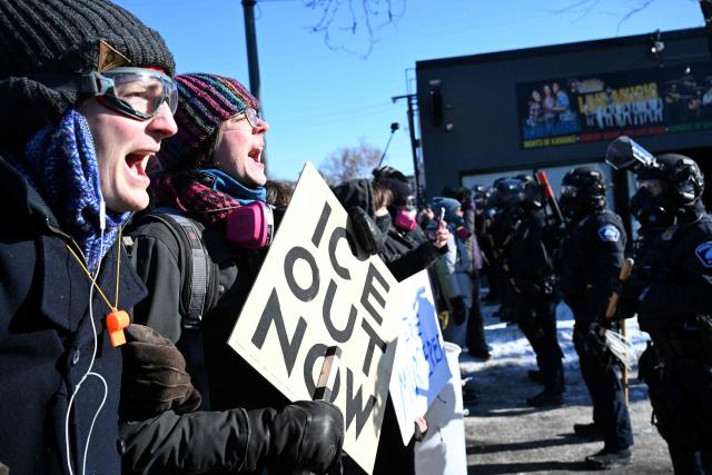 Protesters face off with Minneapolis police officers in Minneapolis, Minnesota, on January 24,2026. Federal immigration agents shot dead a man in Minneapolis on Saturday, officials said -- the second fatal shooting of a civilian in the city, sparking fresh protests and outrage from state officials. The death came less than three weeks after US citizen Renee Good was shot and killed by an Immigration and Customs Enforcement officer involved in sweeps to round up undocumented migrants. (Photo by ROBERTO SCHMIDT / AFP)