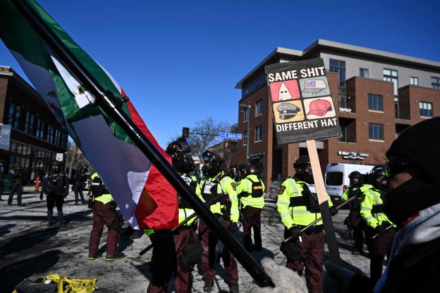 Protesters face off with Minnesota Department of Natural Resources Conservation officers in Minneapolis, Minnesota, on January 24,2026. Federal immigration agents shot dead a man in Minneapolis on Saturday, officials said -- the second fatal shooting of a civilian in the city, sparking fresh protests and outrage from state officials. The death came less than three weeks after US citizen Renee Good was shot and killed by an Immigration and Customs Enforcement officer involved in sweeps to round up undocumented migrants. (Photo by ROBERTO SCHMIDT / AFP)