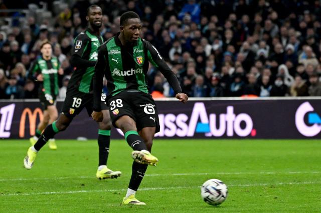 Lens' French forward #38 Rayan Fofana takes a shot to score a goal during the French L1 football match between Olympique de Marseille (OM) and RC Lens at the Stade Velodrome in Marseille, southern France, on January 24, 2026. (Photo by Miguel MEDINA / AFP)