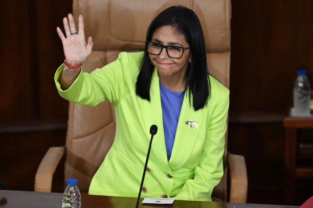 (FILES) Venezuela's interim President Delcy Rodriguez waves during a presidential address to Parliament at the National Assembly in Caracas on January 15, 2026. Venezuela's interim president Delcy Rodriguez called on January 24, 2026, for discussions with the opposition to reach "agreements" for peace, three weeks after the US ouster of her former boss, Nicolas Maduro. (Photo by Federico PARRA / AFP)
