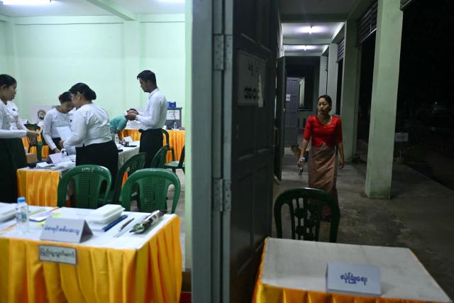 Volunteers from the Union Election Commission (UEC) make final preparations before the opening of polls on the third and final phase of Myanmar's general election, at a polling station in Yangon on January 25, 2026. Myanmar opened the final round of its month-long election on January 25, with the dominant pro-military party on course for a landslide in a junta-run vote critics say will prolong the army's grip on power. (Photo by Sai Aung MAIN / AFP)