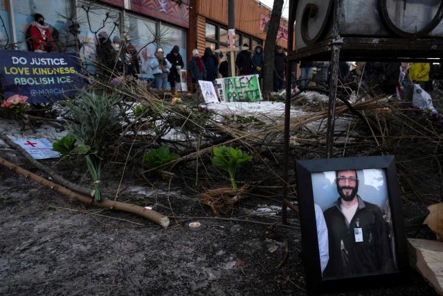 A photograph of 37-year-old Alex Pretti can be seen at a makeshift memorial in the area where he was shot dead by federal immigration agents earlier in the day in Minneapolis, Minnesota, on January 24, 2026. Federal immigration agents shot dead a man in Minneapolis on Saturday, in the second fatal shooting of a civilian during the Trump administration's unprecedented operation in the city, sparking fresh protests and outrage from state officials. The death came less than three weeks after US citizen Renee Good was shot and killed by an ICE officer. (Photo by ROBERTO SCHMIDT / AFP)