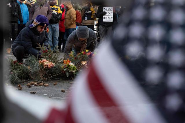 People mourn at a makeshift memorial in the area where 37-year-old Alex Pretti was shot dead by federal immigration agents earlier in the day in Minneapolis, Minnesota, on January 24, 2026. Federal immigration agents shot dead a man in Minneapolis on Saturday, in the second fatal shooting of a civilian during the Trump administration's unprecedented operation in the city, sparking fresh protests and outrage from state officials. The death came less than three weeks after US citizen Renee Good was shot and killed by an ICE officer. (Photo by ROBERTO SCHMIDT / AFP)