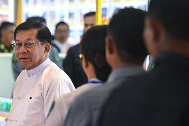 (FILES) Myanmar's junta chief Min Aung Hlaing (L) attends a ceremony to mark the 10th anniversary of the Nationwide Ceasefire Agreement (NCA) in Naypyidaw on October 15, 2025. Myanmar's top general Min Aung Hlaing was months from retirement five years ago when he made an about-face, deposed the democratic government and promoted himself to leader. The bespectacled officer became military chief in 2011, just as Myanmar broke with its history of iron-fisted martial rule and began its latest experiment with democracy. (Photo by AFP)