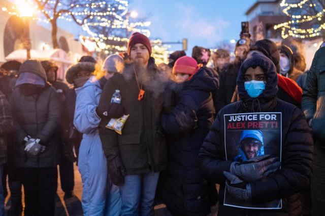 People mourn at a makeshift memorial in the area where 37-year-old Alex Pretti was shot dead by federal immigration agents earlier in the day in Minneapolis, Minnesota, on January 24, 2026. Federal immigration agents shot dead a man in Minneapolis on Saturday, in the second fatal shooting of a civilian during the Trump administration's unprecedented operation in the city, sparking fresh protests and outrage from state officials. The death came less than three weeks after US citizen Renee Good was shot and killed by an ICE officer. (Photo by ROBERTO SCHMIDT / AFP)