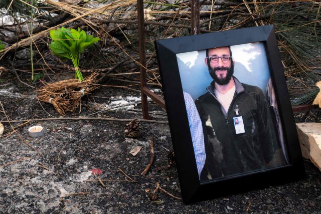 A photograph of 37-year-old Alex Pretti can be seen at a makeshift memorial in the area where he was shot dead by federal immigration agents earlier in the day in Minneapolis, Minnesota, on January 24, 2026. Federal immigration agents shot dead a man in Minneapolis on Saturday, in the second fatal shooting of a civilian during the Trump administration's unprecedented operation in the city, sparking fresh protests and outrage from state officials. The death came less than three weeks after US citizen Renee Good was shot and killed by an ICE officer. (Photo by ROBERTO SCHMIDT / AFP)