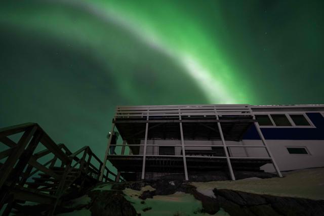 Northern Lights (Aurora Borealis) glow above the city of Nuuk during a power outage on January 25, 2026, in Greenland. (Photo by Jonathan NACKSTRAND / AFP)