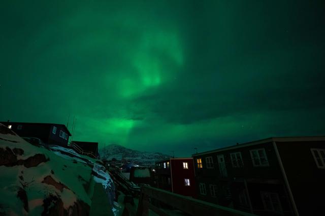 Northern Lights (Aurora Borealis) glow above the city of Nuuk during a power outage on January 25, 2026, in Greenland. (Photo by Jonathan NACKSTRAND / AFP)