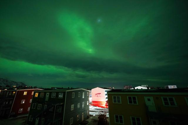 Northern Lights (Aurora Borealis) glow above the city of Nuuk during a power outage on January 25, 2026, in Greenland. (Photo by Jonathan NACKSTRAND / AFP)