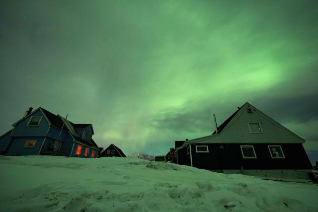 Northern Lights (Aurora Borealis) glow above the city of Nuuk during a power outage on January 25, 2026, in Greenland. (Photo by Jonathan NACKSTRAND / AFP)