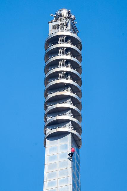 US rock climber Alex Honnold closes in to the top of the Taipei 101 building as he free soloes the landmark skyscraper without ropes or safety gear in Taipei on January 25, 2026. (Photo by I-Hwa Cheng / AFP)
