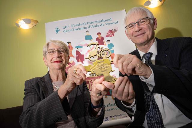 (FILES) Directors of the Festival International des Cinemas d’Asie (FICA - International Festival of Asian Cinema), Martine and Jean-Marc Therouanne, pose with the golden cycle trophy in Vesoul, eastern France, on January 25, 2024. Executions in Sri Lanka, oppression of women in Kyrgyzstan, suicide in Korea... the Asian Film Festival opens on January 27, 2026 in Vesoul, with a competition dominated by the torments of the contemporary world. (Photo by SEBASTIEN BOZON / AFP)