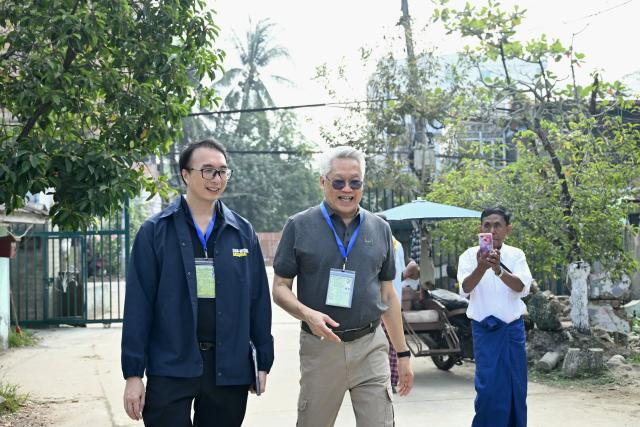 International observers arrive at a polling station during the third and final phase of Myanmar's general election in Yangon on January 25, 2026. Myanmar opened the final round of its month-long election on January 25, with the dominant pro-military party on course for a landslide in a junta-run vote critics say will prolong the army's grip on power. (Photo by Sai Aung MAIN / AFP)