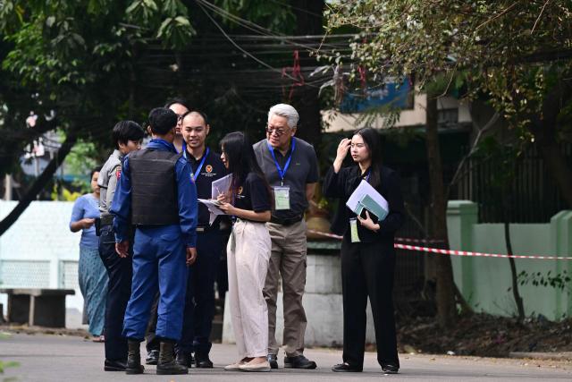 Police check International observers as they arrive at a polling station during the third and final phase of Myanmar's general election in Yangon on January 25, 2026. Myanmar opened the final round of its month-long election on January 25, with the dominant pro-military party on course for a landslide in a junta-run vote critics say will prolong the army's grip on power. (Photo by Sai Aung MAIN / AFP)