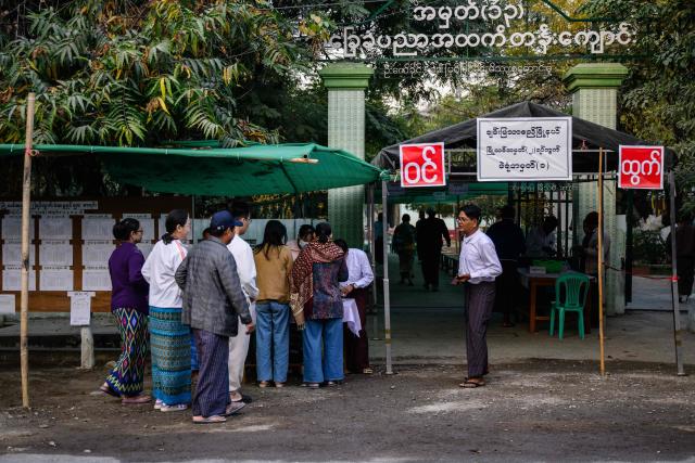 Voters arrive outside a polling station during the third and final phase of Myanmar's general election in Mandalay on January 25, 2026. Myanmar opened the final round of its month-long election on January 25, with the dominant pro-military party on course for a landslide in a junta-run vote critics say will prolong the army's grip on power. (Photo by ANTHONY WALLACE / AFP)