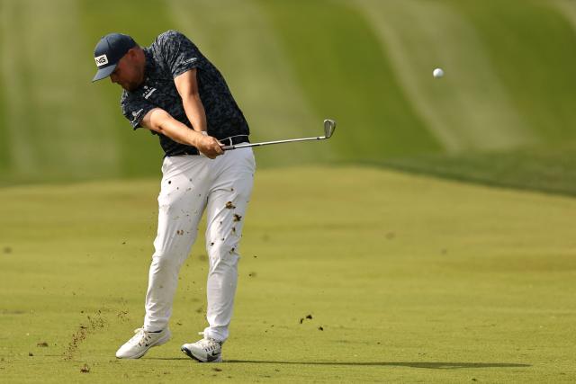 England's Dan Bradbury plays a shot on the 1st hole during the Hero Dubai Desert Classic golf tournament at the Emirates Golf Club in Dubai on January 25, 2026. (Photo by Fadel SENNA / AFP)