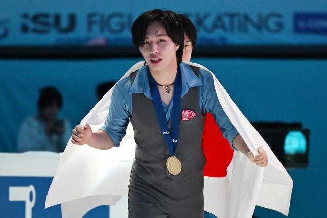 Gold medallist Japan’s Kao Miura skates with his medal after winning the men's competition at the ISU Four Continents Figure Skating Championships in Beijing on January 25, 2026. (Photo by GREG BAKER / AFP)