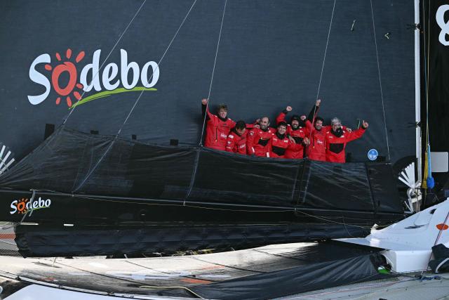 French skipper Thomas Coville and his crew members celebrate aboard the Ultim class multihull "Sodebo Ultim 3" as they arrive at the end of their Jules Verne Trophy attempt, in the Atlantic Ocean, off the coast of Brest, Brittany, western France, on January 25, 2026. Thomas Coville (Sodebo) and his six crew members completed a non-stop round-the-world voyage off the coast of Brest on January 25, 2026 in a record time of 40 days, 10 hours and 45 minutes, beating the previous Jules Verne Trophy record by 12 hours, his team announced. The Jules Verne Trophy is a prize for the fastest crewed, unassisted and non-stop circumnavigation of the world on any type of yacht. (Photo by LOIC VENANCE / AFP)