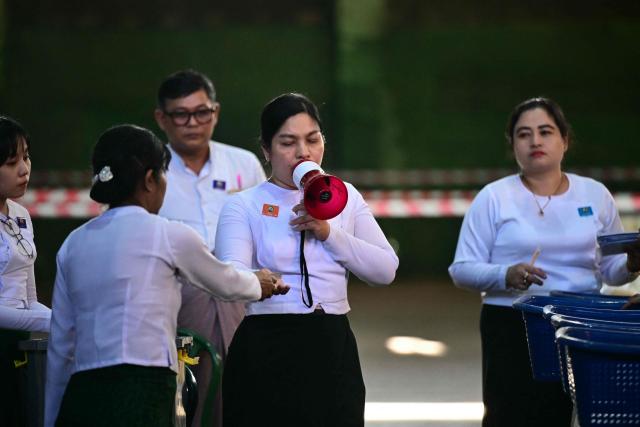 Members of Myanmar’s Union Election commission (UEC) count ballots after the closing of polls at a polling station in the third phase of Myanmar’s general election in Yangon on January 25, 2026. (Photo by Sai Aung MAIN / AFP)