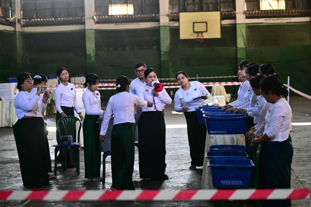 Members of Myanmar’s Union Election commission (UEC) count ballots after the closing of polls at a polling station in the third phase of Myanmar’s general election in Yangon on January 25, 2026. (Photo by Sai Aung MAIN / AFP)