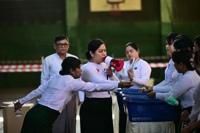 Members of Myanmar’s Union Election commission (UEC) count ballots after the closing of polls at a polling station in the third phase of Myanmar’s general election in Yangon on January 25, 2026. (Photo by Sai Aung MAIN / AFP)