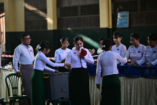 Members of Myanmar’s Union Election commission (UEC) count ballots after the closing of polls at a polling station in the third phase of Myanmar’s general election in Yangon on January 25, 2026. (Photo by Sai Aung MAIN / AFP)