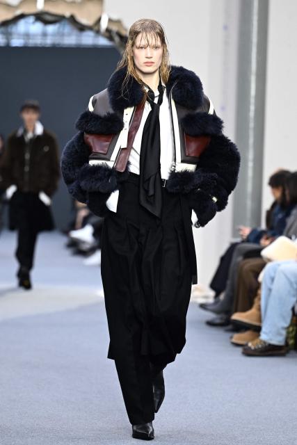 A model presents a creation by Sacai for the Menswear Ready-to-wear Fall-Winter 2026/2027 collection as part of the Men Paris Fashion Week in Paris on January 25, 2026.  (Photo by Blanca CRUZ / AFP)
