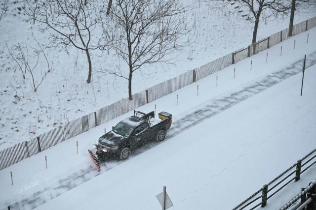 A truck plows a snow covered road in the Brooklyn borough of New York City on January 25, 2026. A massive winter storm on January 24 dumped snow and freezing rain from New Mexico to North Carolina as it swept across the United States towards the northeast, threatening tens of millions of Americans with blackouts, transportation chaos and bone-chilling cold. After battering the country's southwest and central areas, the storm system began to hit the heavily populated mid-Atlantic and northeastern states as a frigid air mass settled in across the nation. (Photo by ANGELA WEISS / AFP)