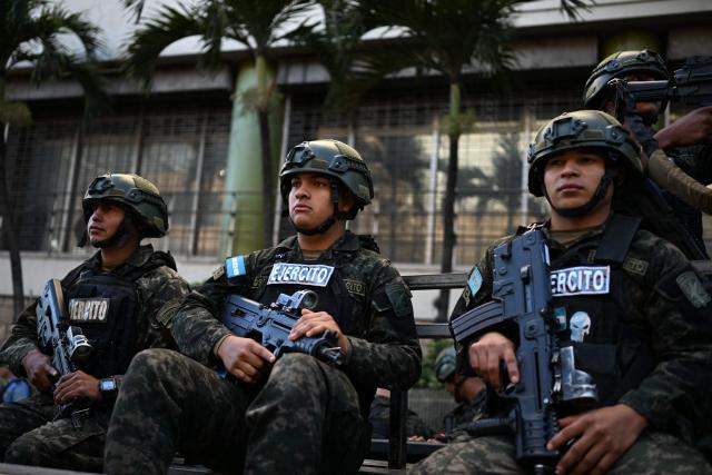 Honduran soldiers stand guard outside the congress prior to the installation of the first legislature, in Tegucigalpa on January 25, 2026. Earliert this month Honduras electoral authorities rejected an order by the outgoing president to recount November's election won by Trump-backed candidate Nasry Asfura, a conservative businessman who was declared the winner of Honduras's presidential election on December 24, weeks after a tight race marred by delays and allegations of fraud. (Photo by Johan ORDONEZ / AFP)