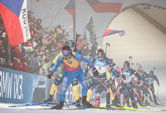Italy's Tommaso Giacomel (Front) competes in the men's 15 km mass start competition of the IBU Biathlon World Cup in Nove Mesto, Czech Republic, on January 25,  2026. (Photo by Radek MICA / AFP)