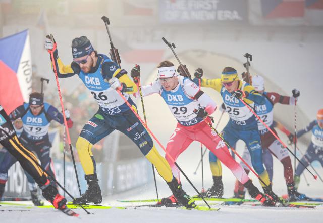 Sweden's Malte Stefansson (L) and Poland's Konrad Badacz (C) compete in the men's 15 km mass start competition of the IBU Biathlon World Cup in Nove Mesto, Czech Republic, on January 25,  2026. (Photo by Radek MICA / AFP)