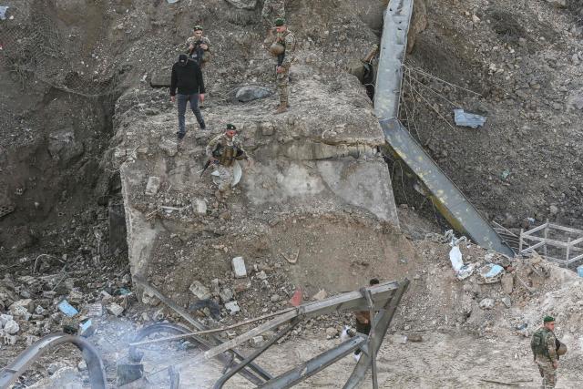 Lebanese soldiers inspect the scene following an Israeli airstrike that targeted a building in the southern Lebanese village of Kfar Dounine on January 25, 2026. An Israeli strike on south Lebanon killed one person on Janauary 25, the health ministry reported, as Israel's military said it struck Hezbollah targets. More than 350 people have been killed by Israeli fire in Lebanon despite the November 2024 truce, according to an AFP tally of health ministry reports. (Photo by MAHMOUD ZAYYAT / AFP)
