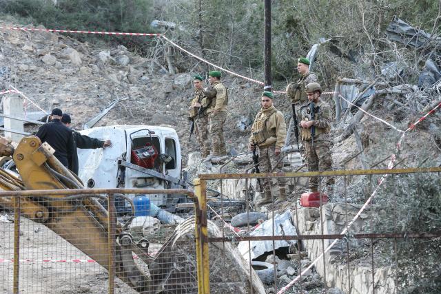 Lebanese soldiers inspect the scene following an Israeli airstrike that targeted a building in the southern Lebanese village of Kfar Dounine on January 25, 2026. An Israeli strike on south Lebanon killed one person on Janauary 25, the health ministry reported, as Israel's military said it struck Hezbollah targets. More than 350 people have been killed by Israeli fire in Lebanon despite the November 2024 truce, according to an AFP tally of health ministry reports. (Photo by MAHMOUD ZAYYAT / AFP)