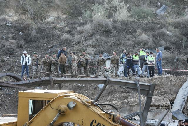 Lebanese soldiers inspect the scene following an Israeli airstrike that targeted a building in the southern Lebanese village of Kfar Dounine on January 25, 2026. An Israeli strike on south Lebanon killed one person on Janauary 25, the health ministry reported, as Israel's military said it struck Hezbollah targets. More than 350 people have been killed by Israeli fire in Lebanon despite the November 2024 truce, according to an AFP tally of health ministry reports. (Photo by MAHMOUD ZAYYAT / AFP)
