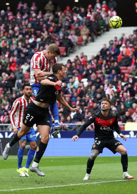 Atletico Madrid's Norwegian forward #09 Alexander Sorloth (TOP) and Real Mallorca's Spanish defender #27 David Lopez vie for a header during the Spanish league football match between Club Atletico de Madrid and RCD Mallorca at Metropolitano Stadium in Madrid on January 25, 2026. (Photo by Pierre-Philippe MARCOU / AFP)