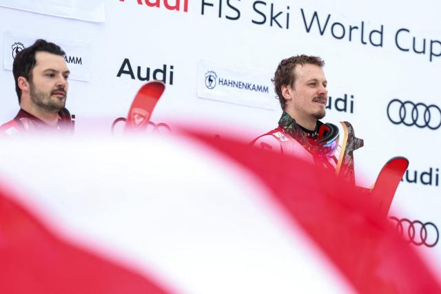 2nd Place Switzerland's Loic Meillard and winner Austria's Manuel Feller celebrate on the podium after the Men's slalom event of the FIS Alpine Skiing World Cup in Kitzbuehel, Austria, on January 25, 2026. (Photo by Johann GRODER / APA / AFP) / Austria OUT